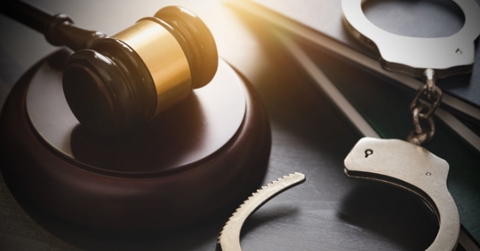 handcuffs and wooden gavel