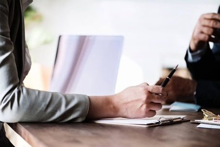 Two people discussing documents at a table