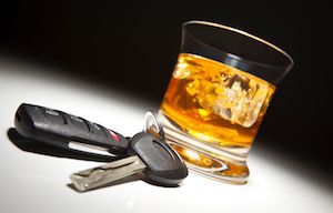 Glass of alcohol next to car keys