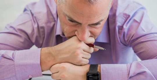 Man with his face in his hands