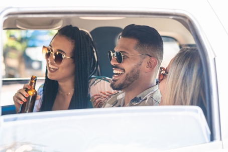 Friends drinking in car