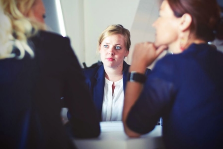 three women having a conversation at a table
