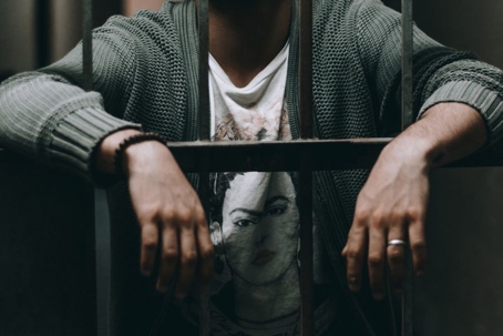 person in jail behind bars